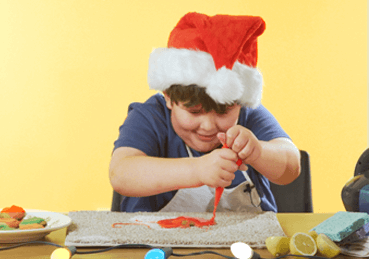 Photo showing Joey making a mess of frosting and trying to clean it up