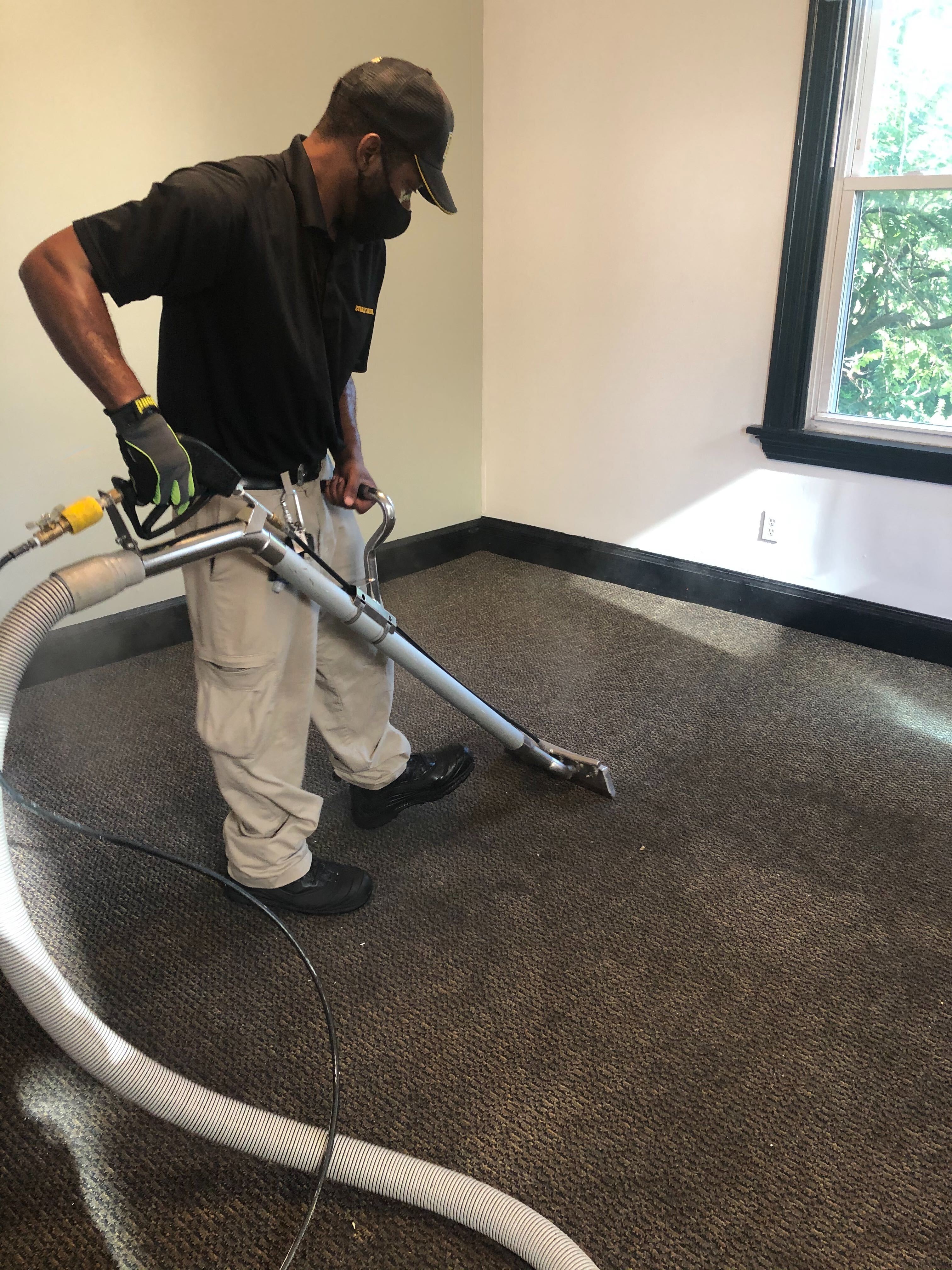Technician cleaning carpet