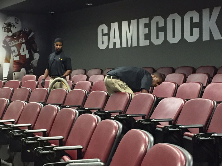 Columbia, South Carolina service technicians cleaning carpets inside of the Gamecock Football stadium.
