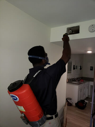 Delray Beach, FLorida air duct cleaning technician cleaning an air duct in a customer's home.