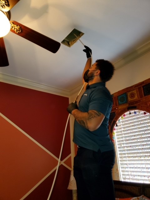 Stanley Steemer Technician Cleaning Air Ducts in Little Rock, AR Bedroom