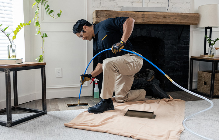 Stanley Steemer Technician Cleaning Air Ducts in Portland, OR Home