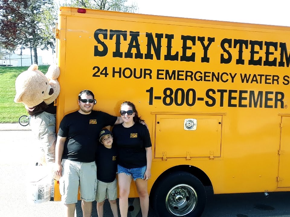 Local Quincy Stanley Steemer owners in front of van