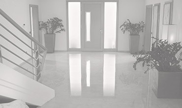 Entryway with sun shining on natural stone floors. 