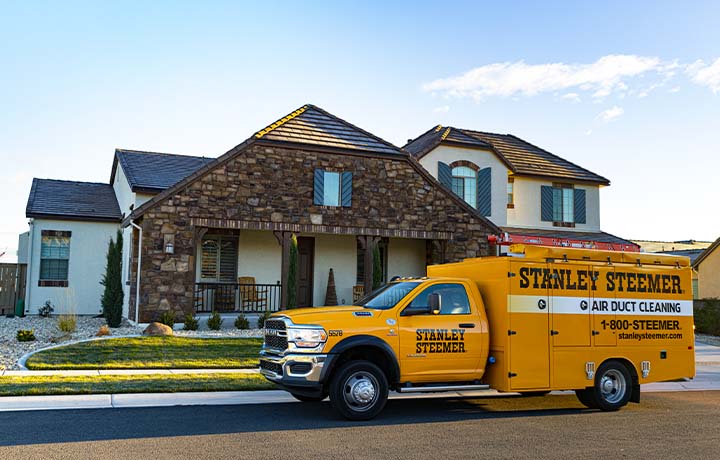 Stanley Steemer air duct cleaning van parked outside of a residential home