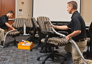 Technicians cleaning office upholstery Technicians cleaning office upholstery