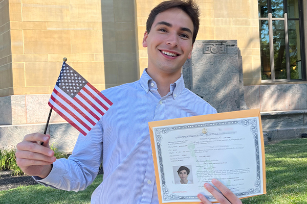 joel with american flag outside state building