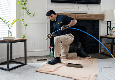 Technician Cleaning Air Ducts Technician Cleaning Air Ducts